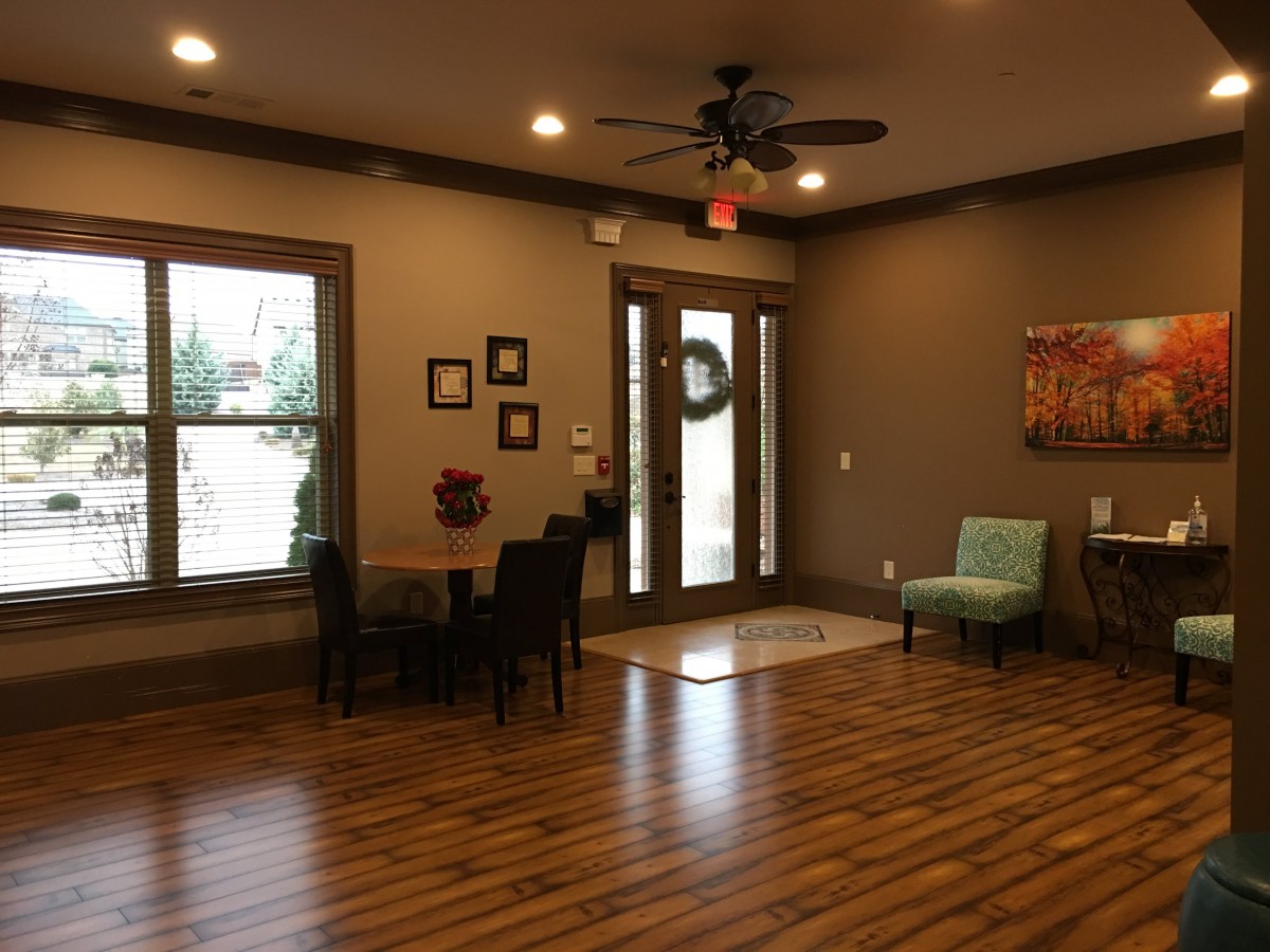 A cozy lobby with wood flooring and comfortable seating.