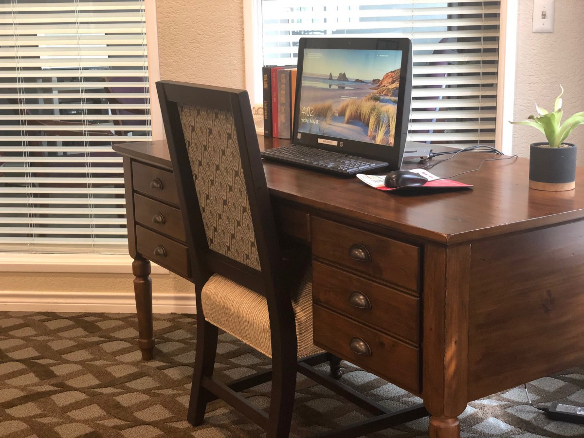 A home office setup with a wooden desk and computer.