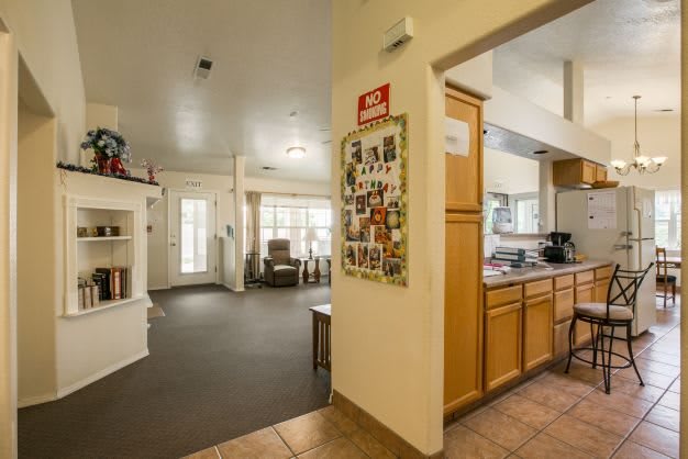 A cozy open-plan living area with a view of the kitchen and seating space.