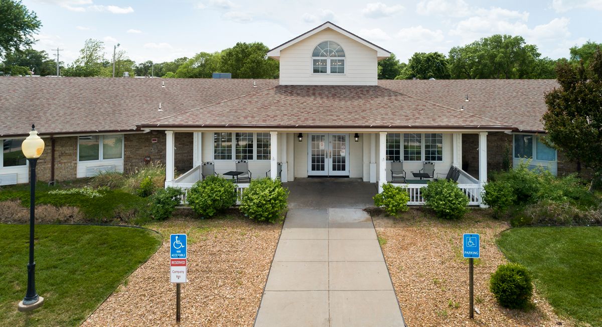 A suburban house with a front porch and landscaped garden.