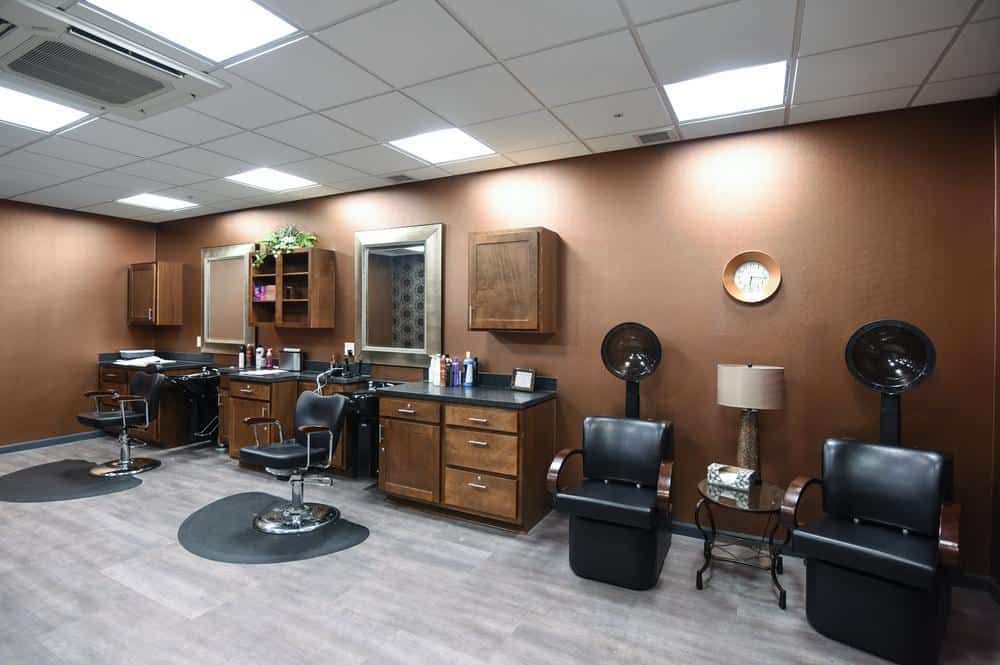 A modern salon interior with grooming chairs and mirrors.
