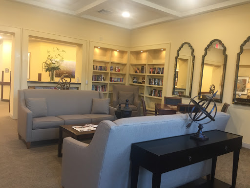 A cozy and inviting living room with modern furniture and well-organized shelves.