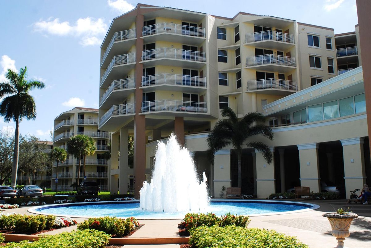 A modern apartment complex featuring a central fountain and balconies.