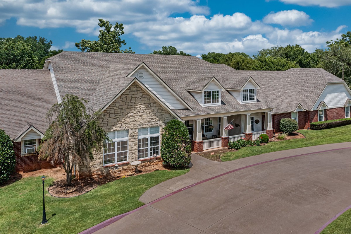 A beautiful suburban house with a well-maintained yard and driveway.