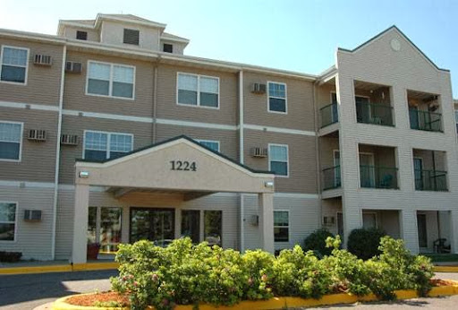 A modern apartment building with a welcoming front entrance and well-maintained landscaping.