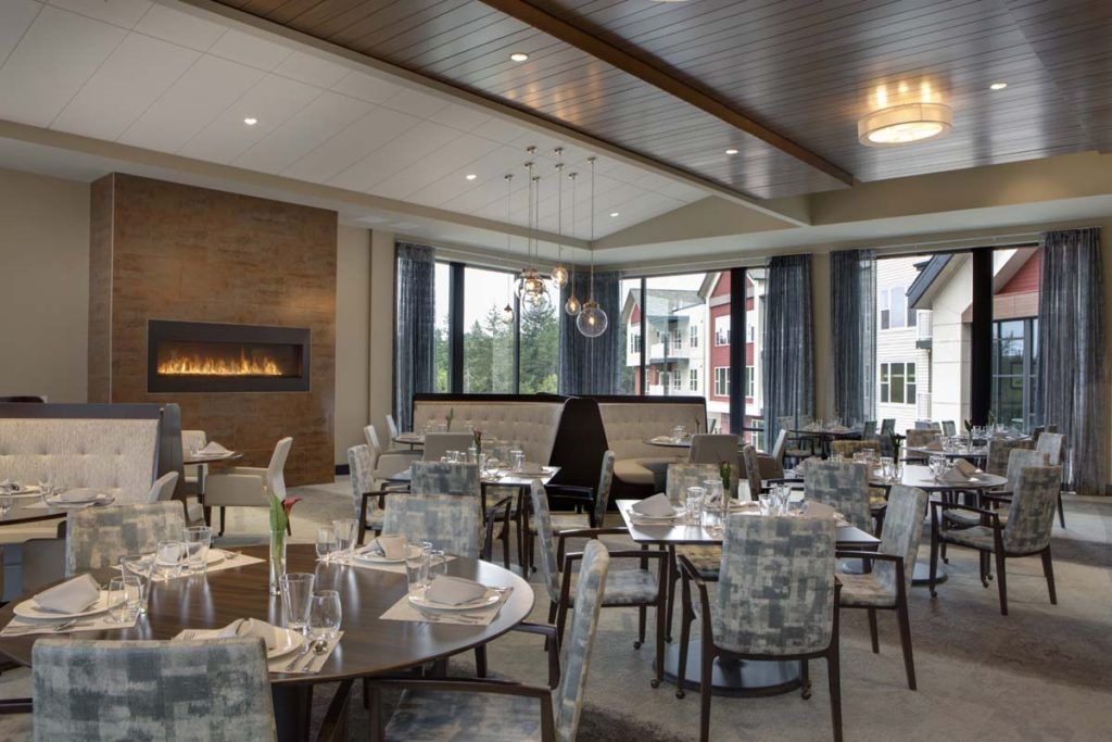 A modern, elegantly designed restaurant interior with tables and chairs set up for dining.