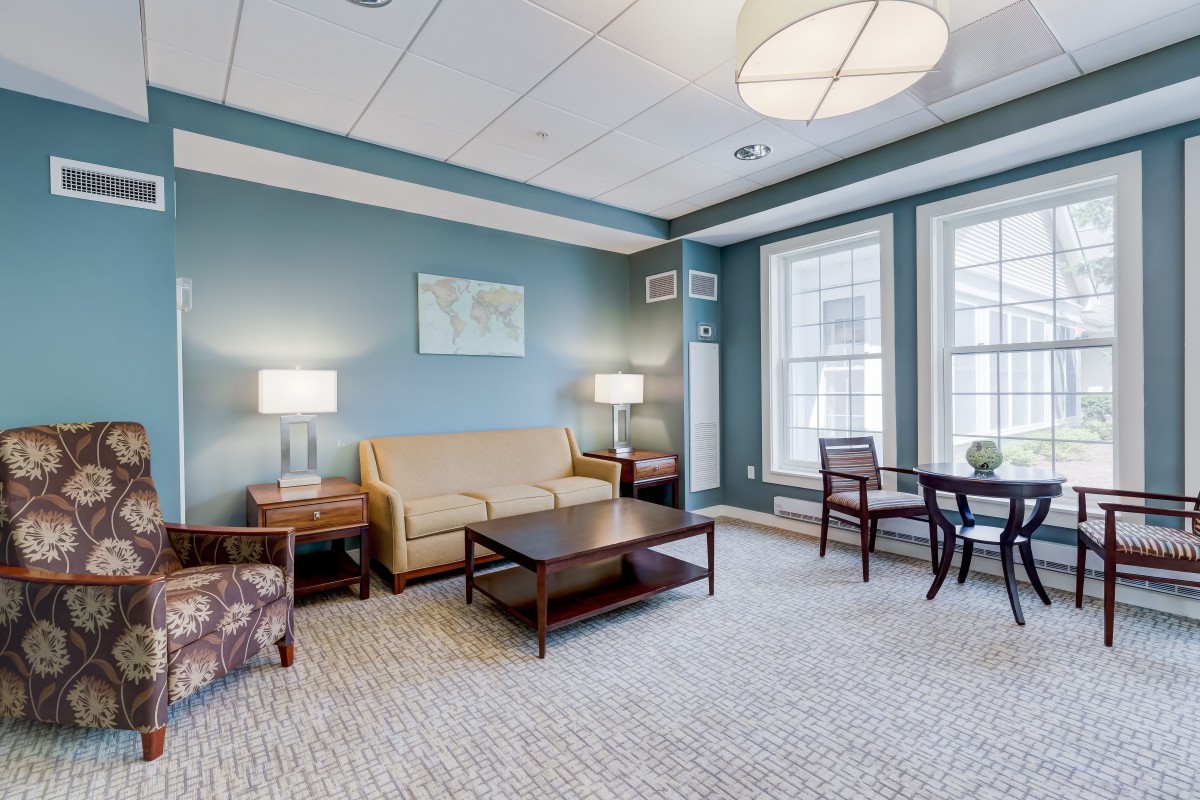 A cozy living room with comfortable seating, elegant lighting, and modern decor.