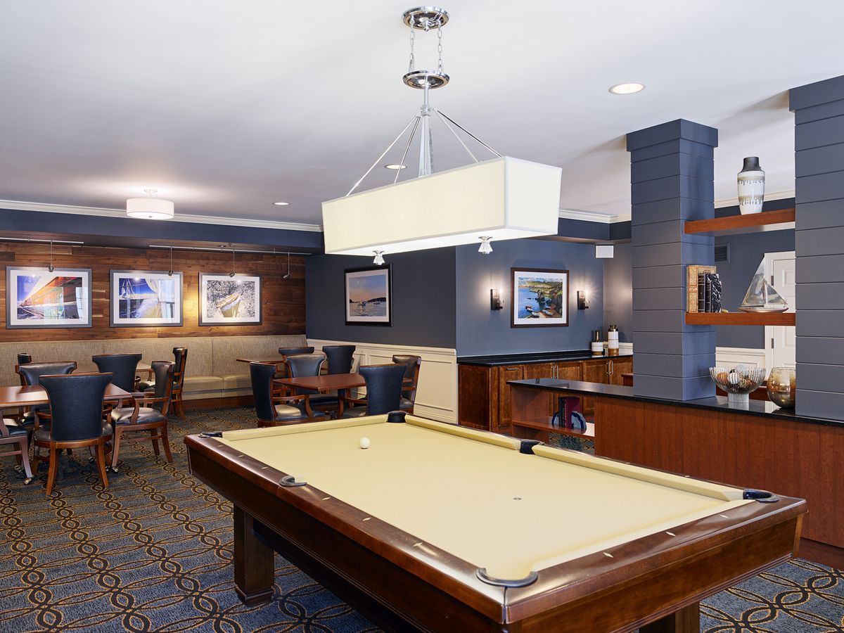 A stylish game room featuring a pool table and modern decor.