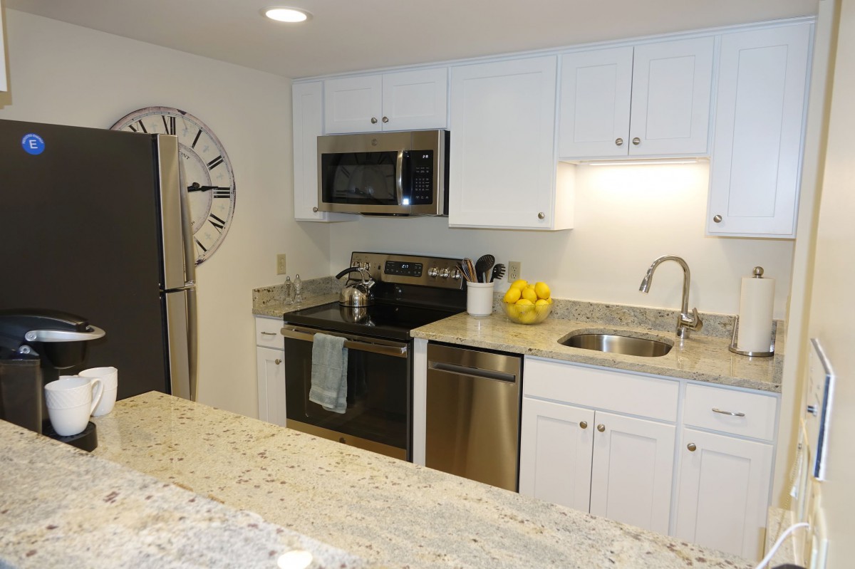 A modern kitchen with stainless steel appliances and granite countertops.