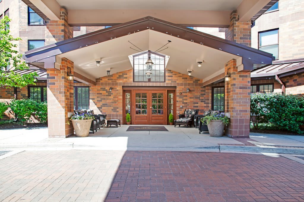 Front entrance of a building with brick architecture and outdoor seating.