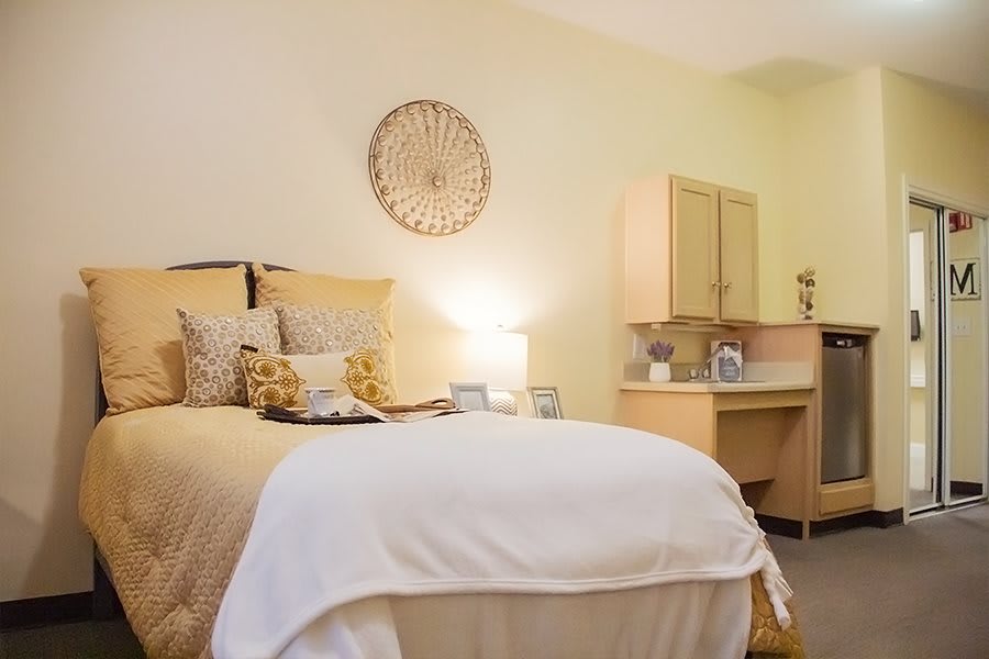 A cozy and well-decorated bedroom with soft lighting and neutral tones.