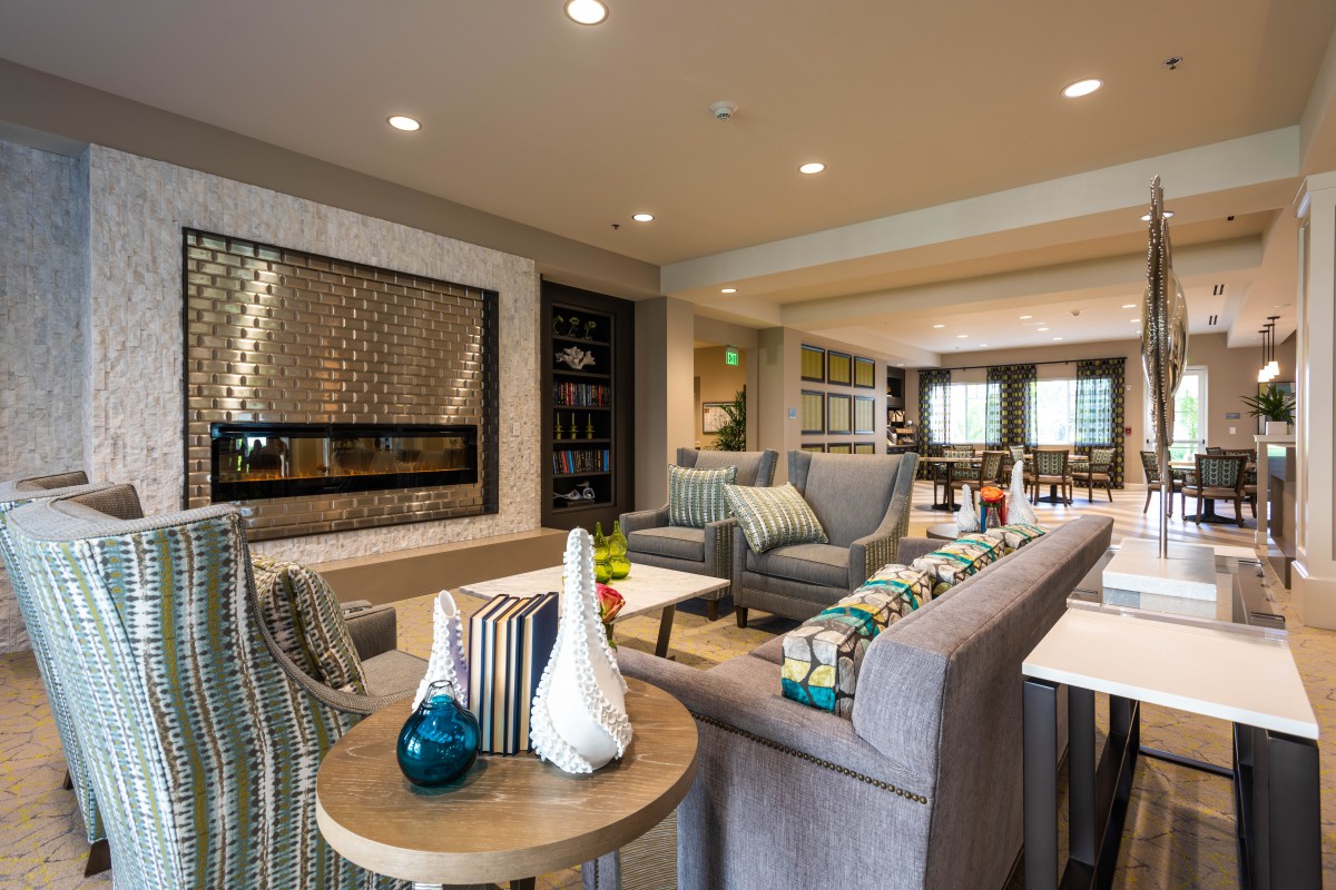 A modern and stylish living room with comfortable seating and a fireplace.