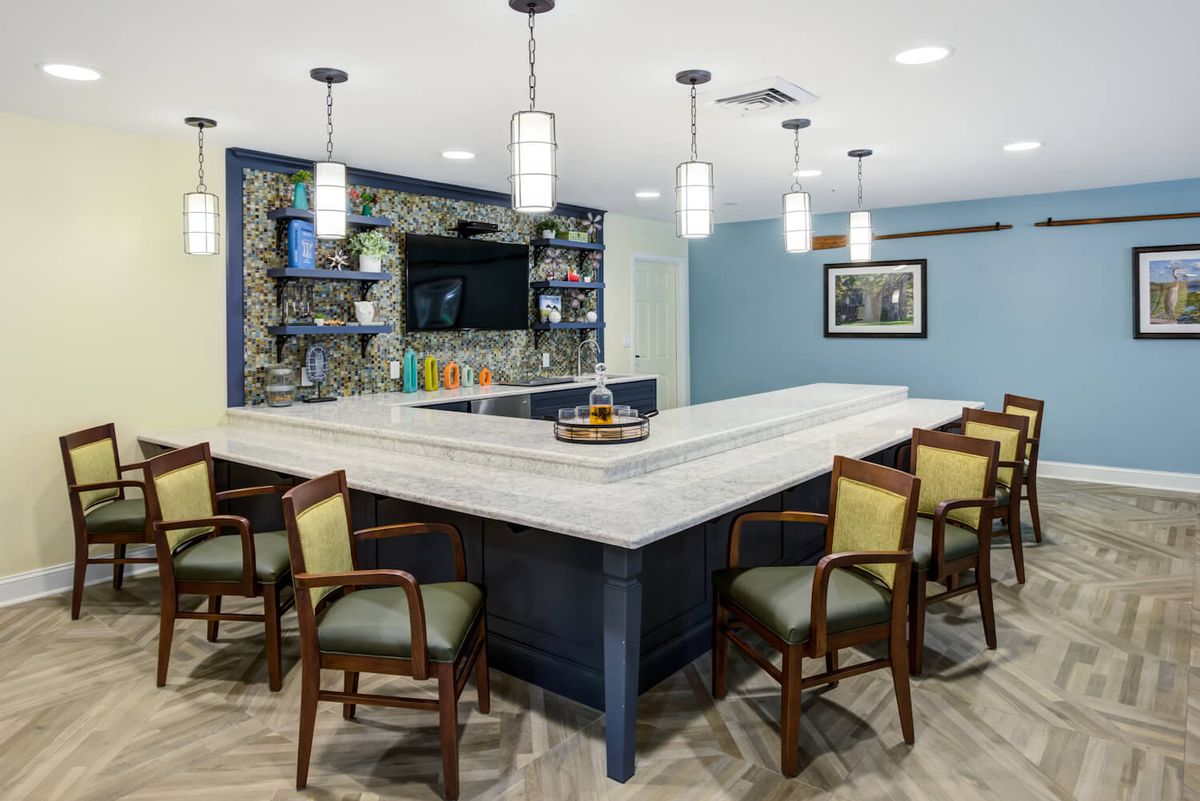 A modern kitchen bar area with stylish lighting and seating.