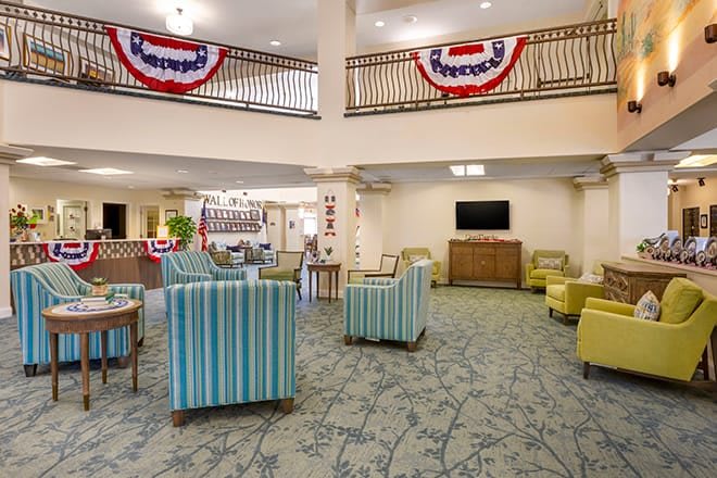 A spacious lobby with comfortable seating and patriotic decorations.