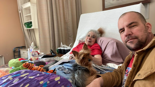 A heartfelt moment shared between a loved one and their furry companion in a cozy bedroom.