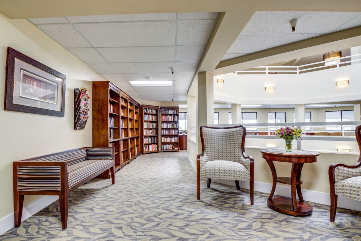 A cozy library corner with bookshelves and comfortable seating.