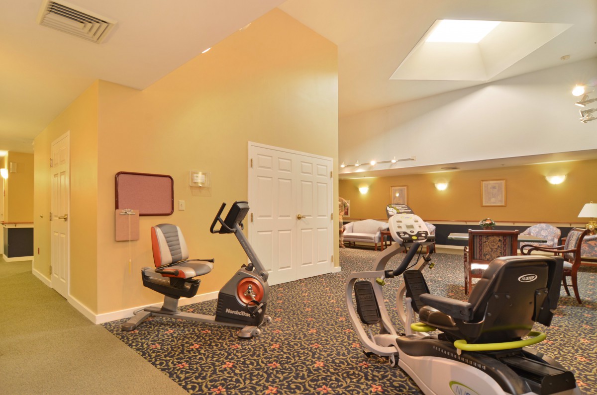 A well-equipped indoor gym featuring exercise bicycles and fitness facilities.