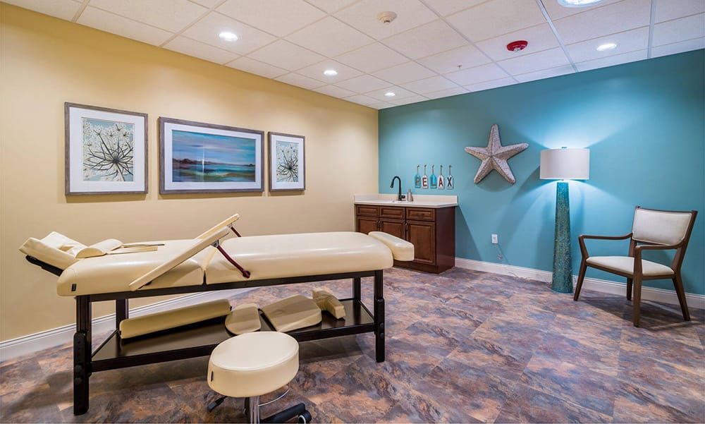 A peaceful massage room featuring a treatment table and soothing decor, ideal for relaxation and wellness therapy.