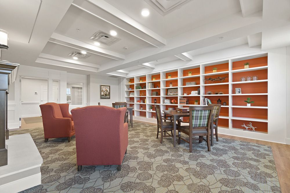 A cozy library interior with bookshelves and a comfortable seating area.