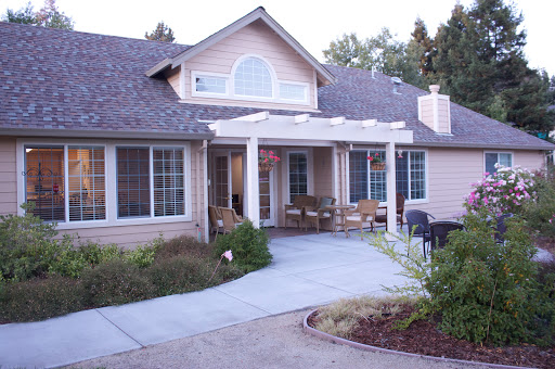 A charming residential house with a welcoming porch and well-maintained landscaping.