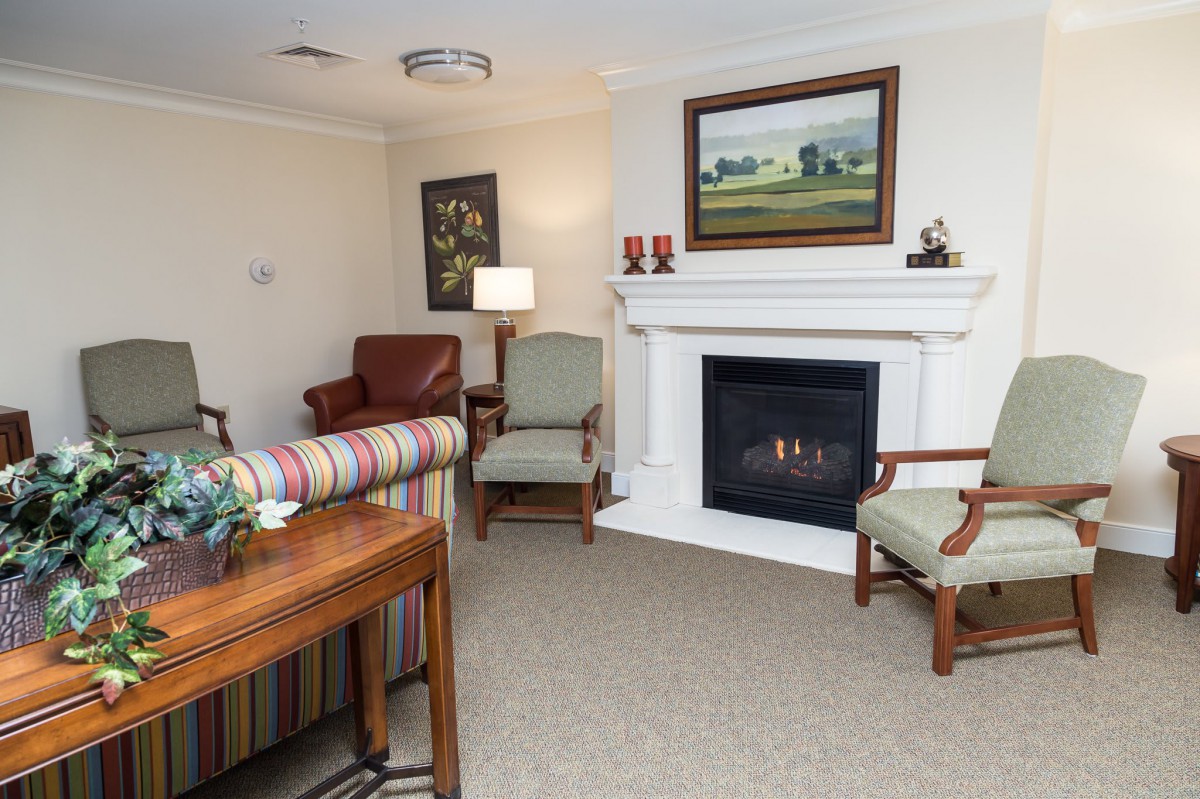 A cozy living room with a fireplace and comfortable seating arrangements.