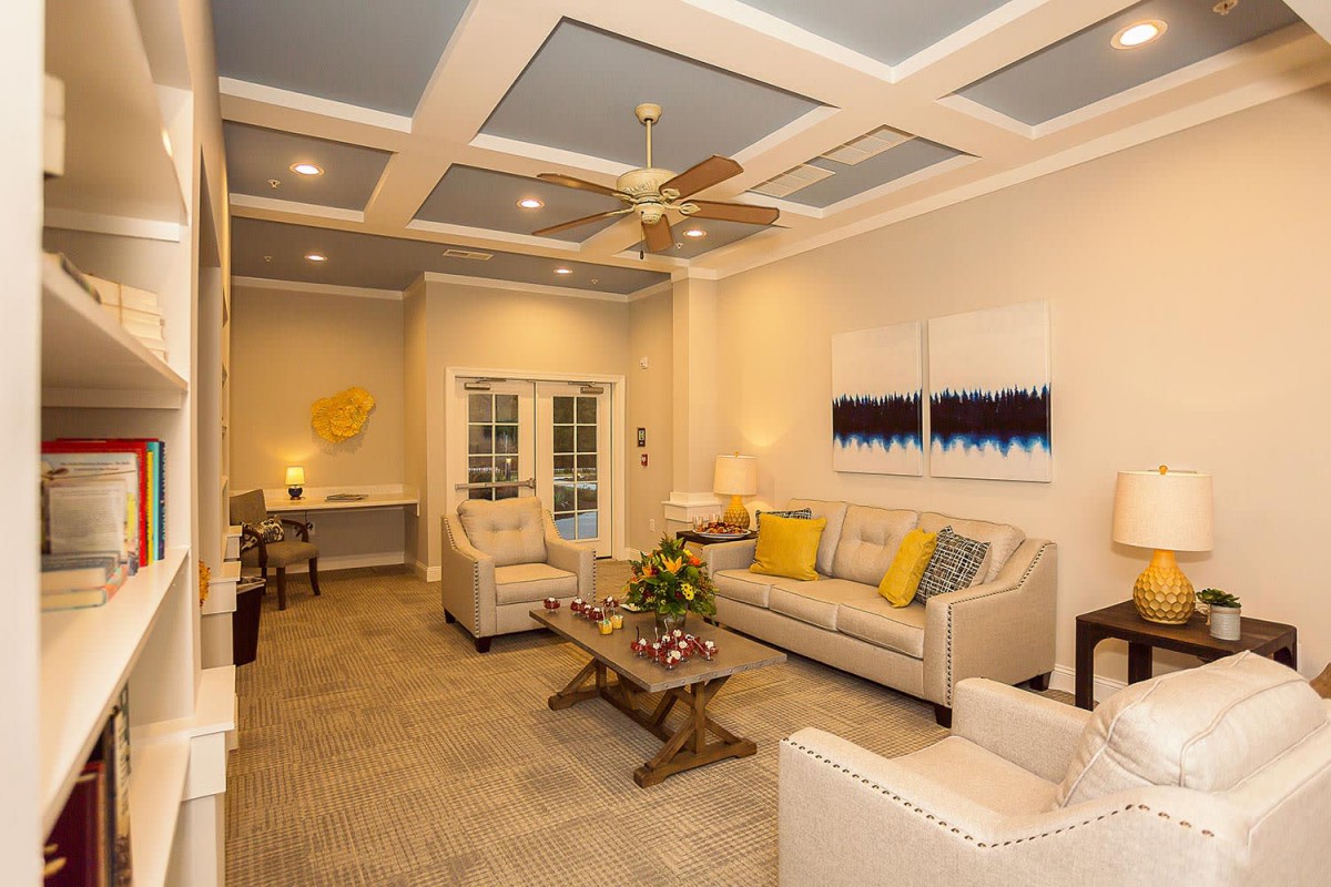 A cozy living room with elegant decor, featuring comfortable seating and stylish artwork.