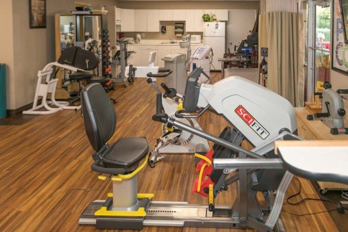 A gym with various exercise machines and fitness equipment.