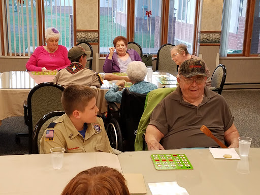 A heartwarming moment at a community bingo event, featuring children and elderly participants enjoying time together.