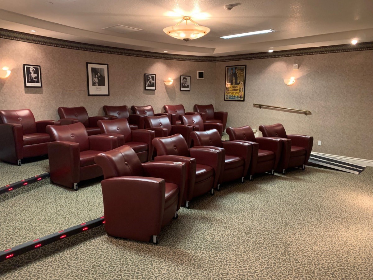 A cozy home theater featuring comfortable leather seating and movie-themed decor.