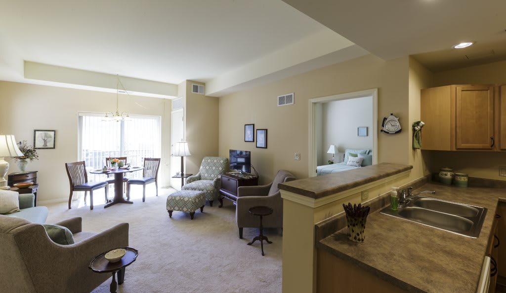 A cozy living room with a dining area, displaying comfortable furniture and ample natural light.