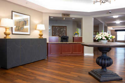 A well-designed lobby with wooden flooring and a reception desk.
