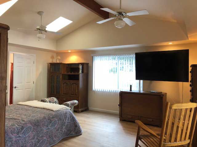 Spacious bedroom with modern amenities and natural light.