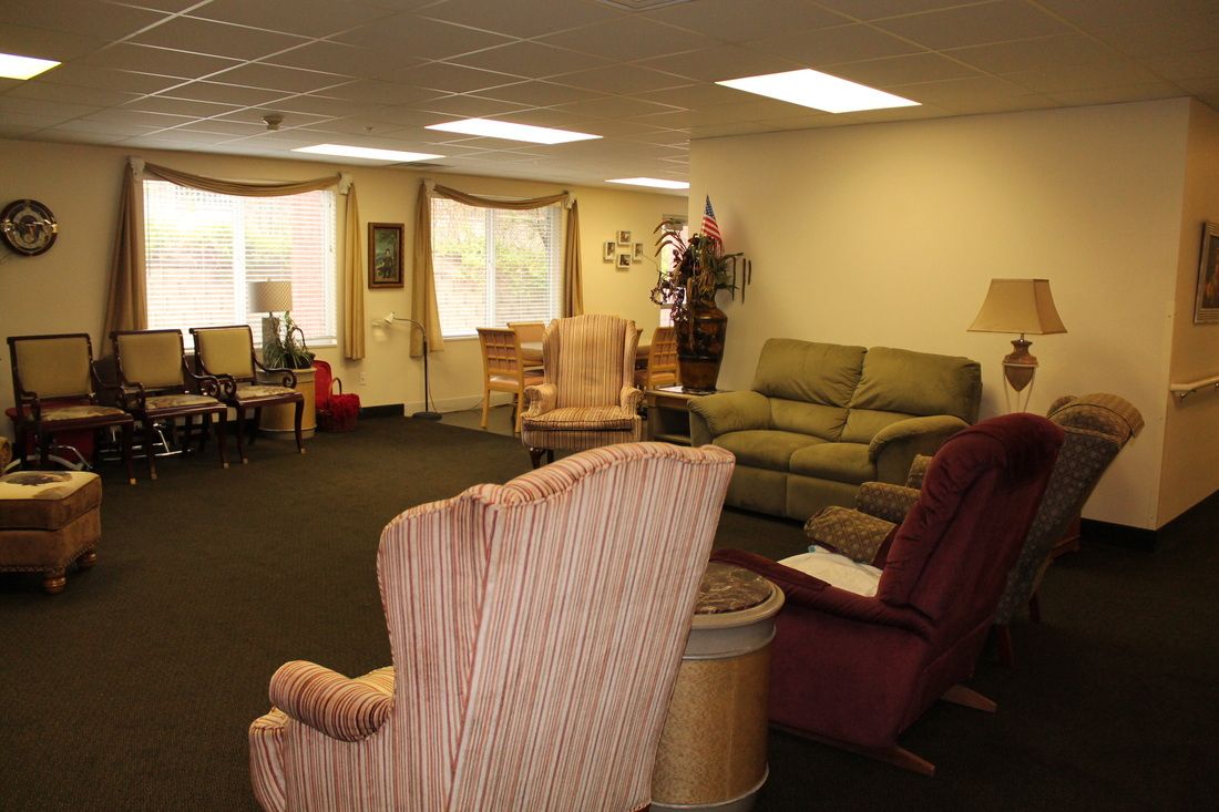 A cozy living room with sofas and chairs arranged for comfort.