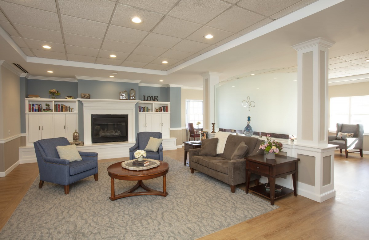 A modern living room with comfortable seating and a fireplace.