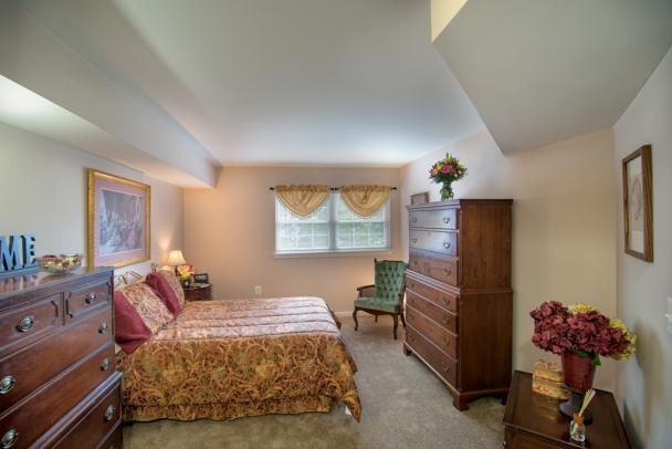A cozy bedroom with classic furniture and soft lighting.