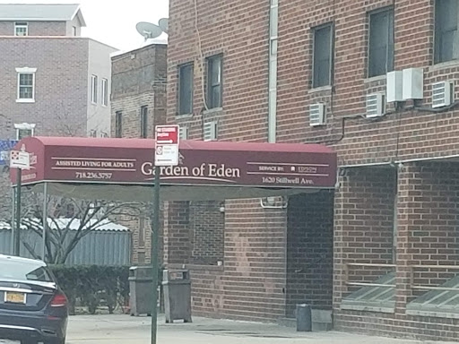 Entrance of a residential building featuring a brick facade and an awning.