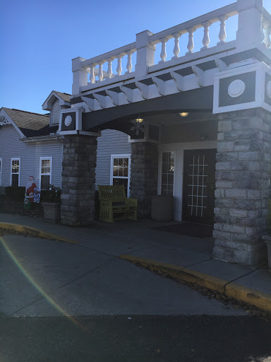 A welcoming hotel entrance featuring a combination of stone and wooden architectural elements.