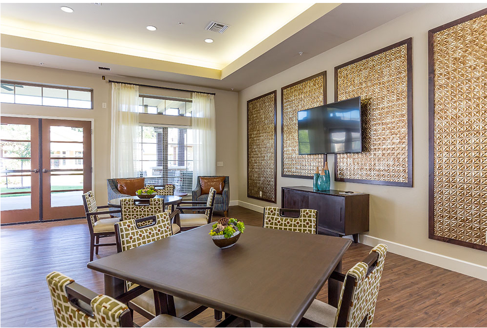 A modern living room with a stylish seating area and television.