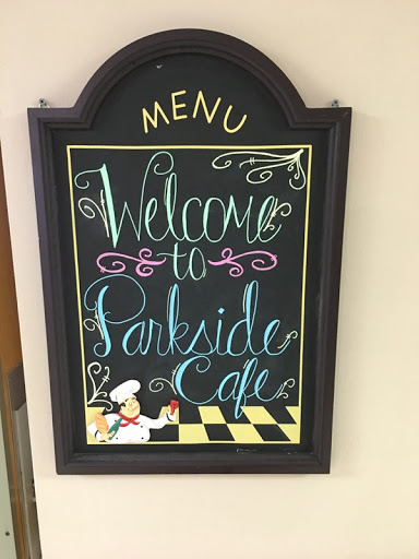 A charming welcome sign for Parkside Cafe, featuring colorful chalkboard art.