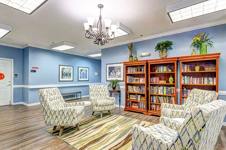 A cozy library seating area with armchairs and bookshelves.