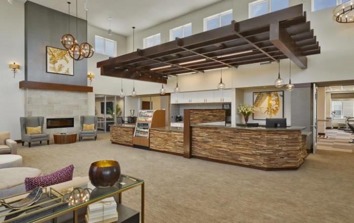 A modern lobby with wood accents and stylish lighting fixtures.