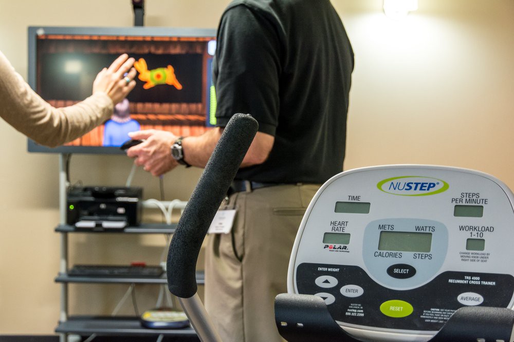 A fitness setup featuring a treadmill and a digital monitor, highlighting health monitoring technology.