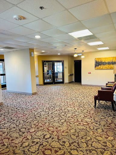 A spacious and inviting lobby area featuring comfortable seating and decorative carpeting.