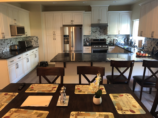 A modern kitchen with a sleek design, featuring an inviting dining area.