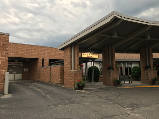 The welcoming entrance of a hospitality establishment under a cloudy sky.