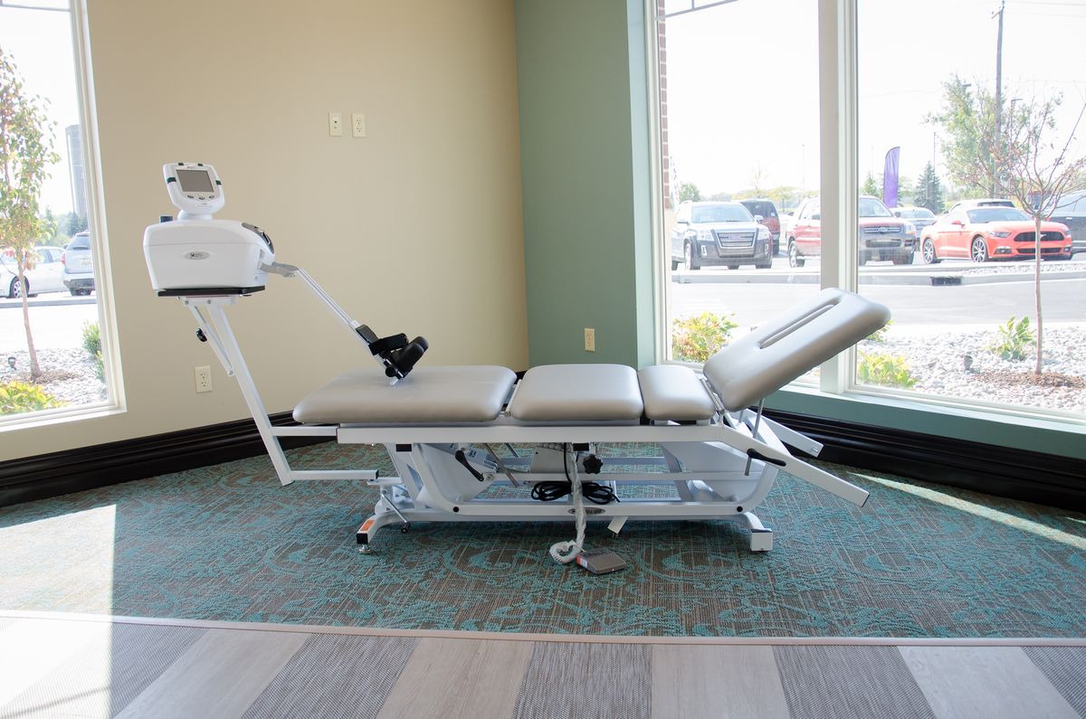 A chiropractic table in a healthcare setting, used for physical therapy and rehabilitation.
