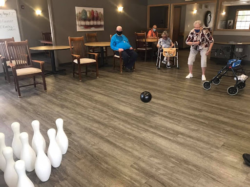 Seniors enjoying a fun bowling game at a recreational center.
