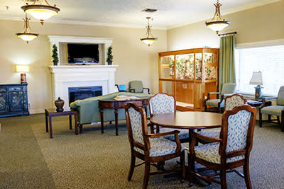 A cozy living room with classic furniture and a fireplace.