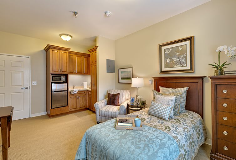 A cozy bedroom with a kitchenette and elegant decor.