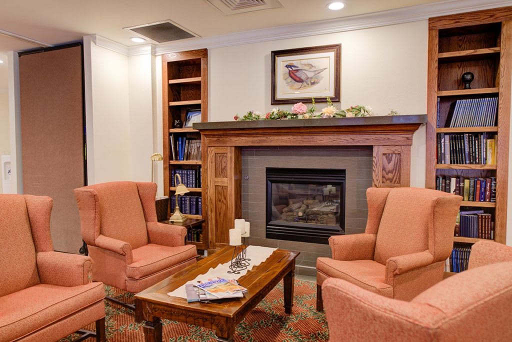Cozy living room with armchairs and a fireplace.